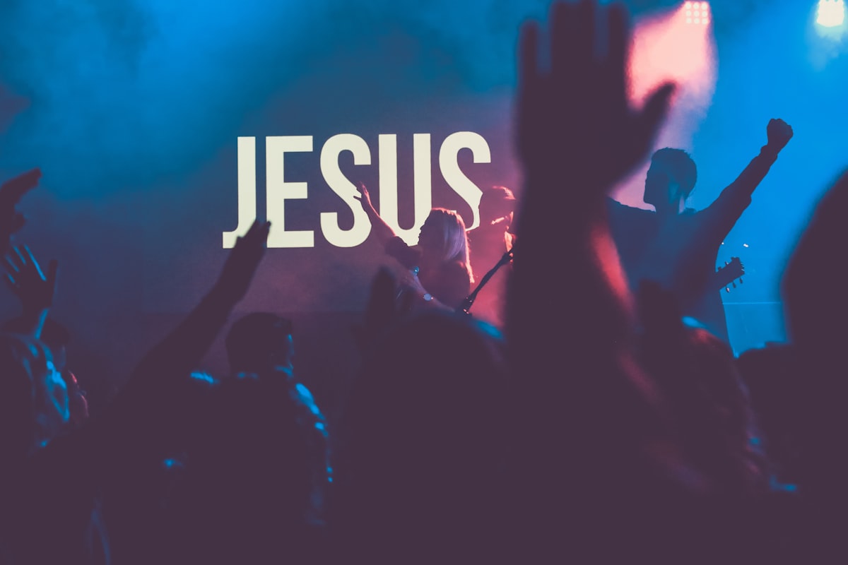 Church worship crowd lifting hands to Jesus